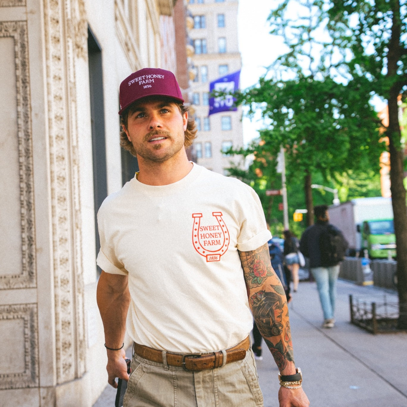 The Every Day Hat maroon snapback styled on city street – Sweet Honey Farm